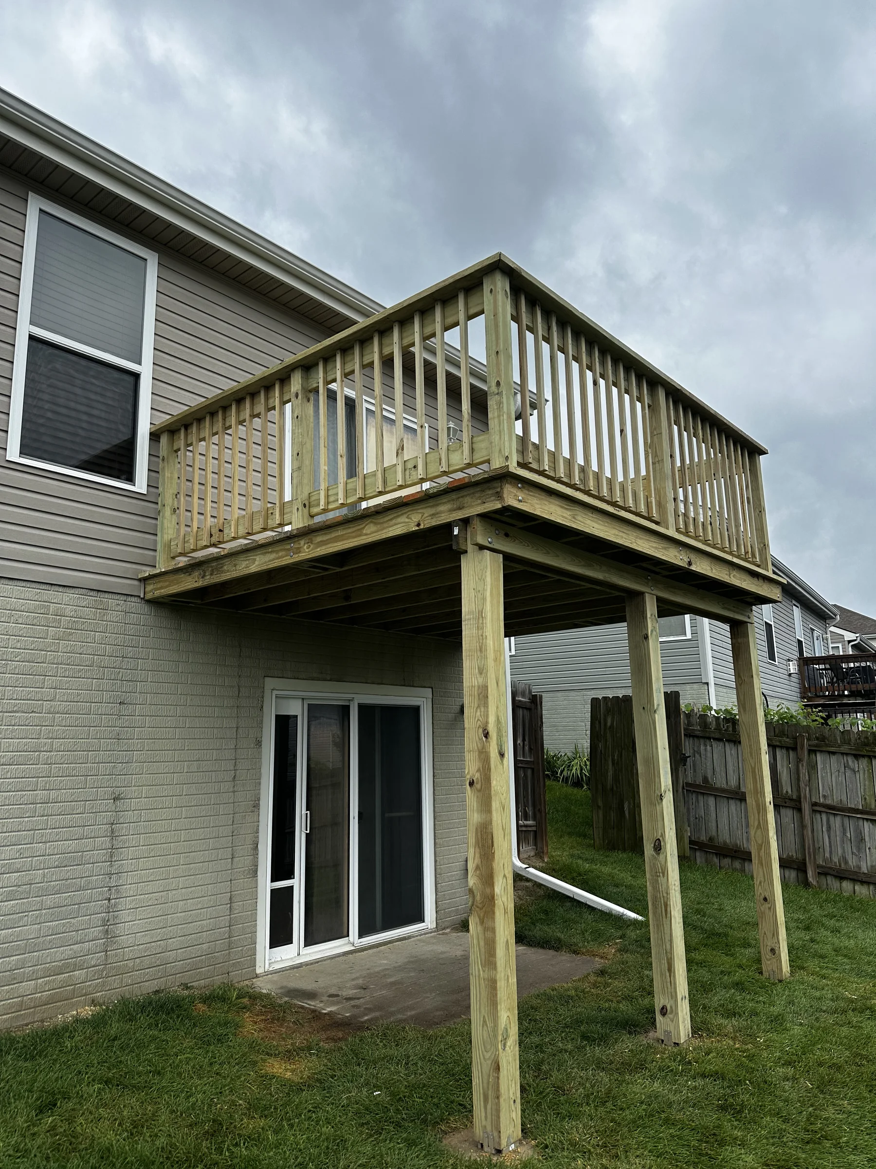 Rebuilt second-story deck with new pressure-treated lumber and railings