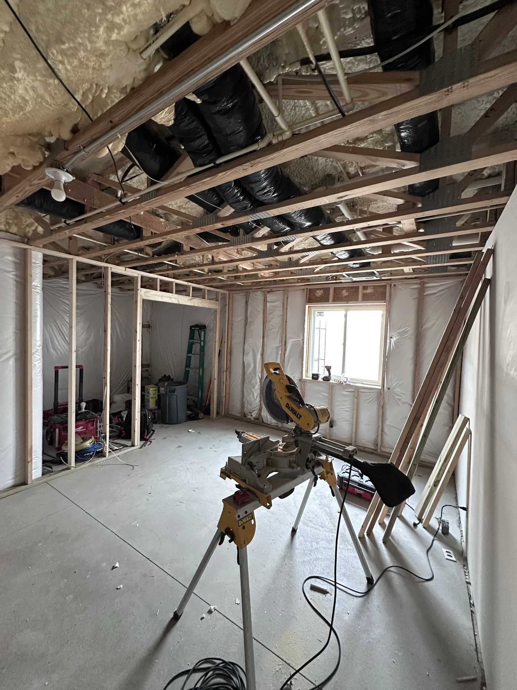 Room framed to studs with insulation, ductwork and a new window, before finish