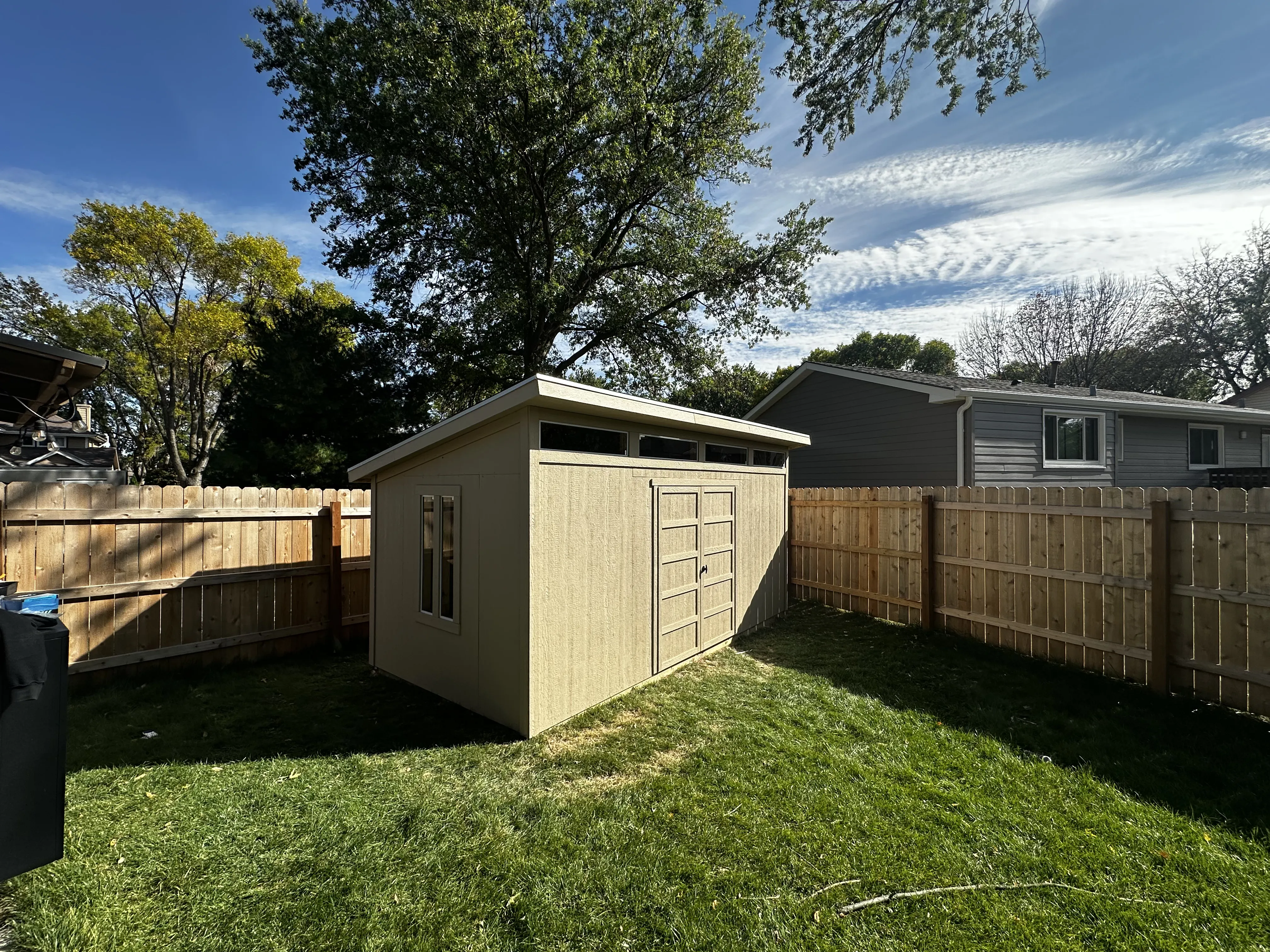 Finished backyard storage shed with clerestory windows